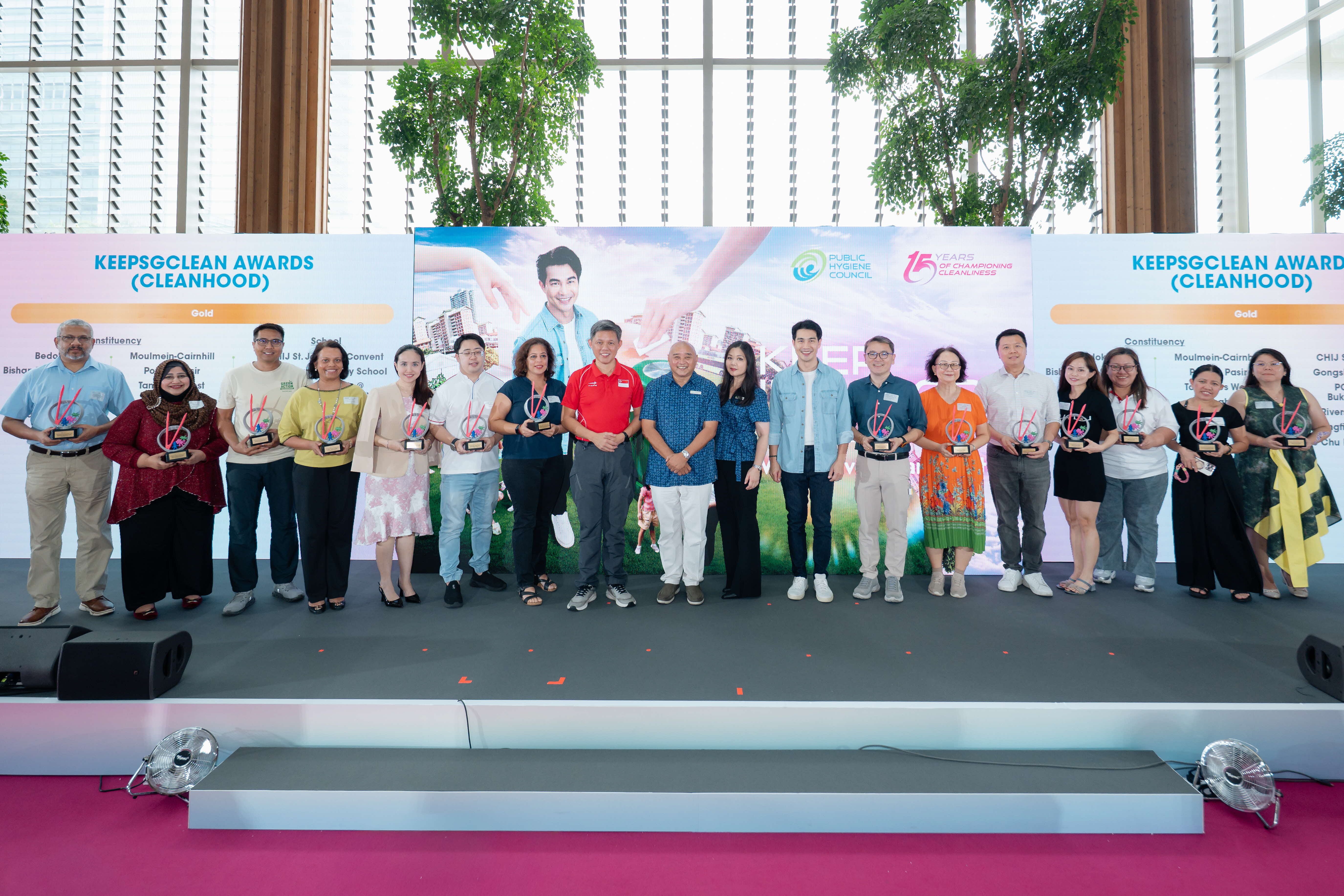 Gold award recipients of the KeepSGClean Awards (CleanHood) posing on stage with their trophies at the Keep Singapore Clean 2026 campaign launch, with the list of CleanHood award recipients displayed on both sides of the Public Hygiene Council backdrop.